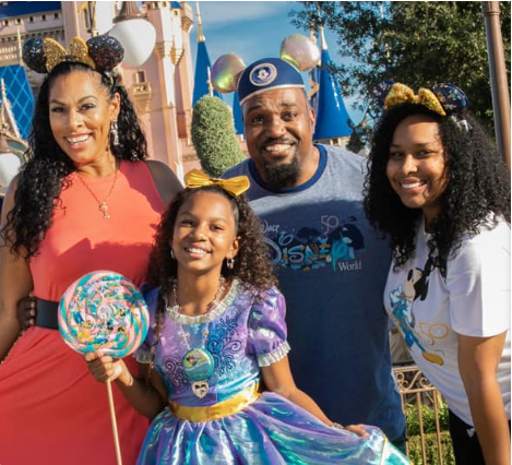 A family is decked out in Disney World merchandise